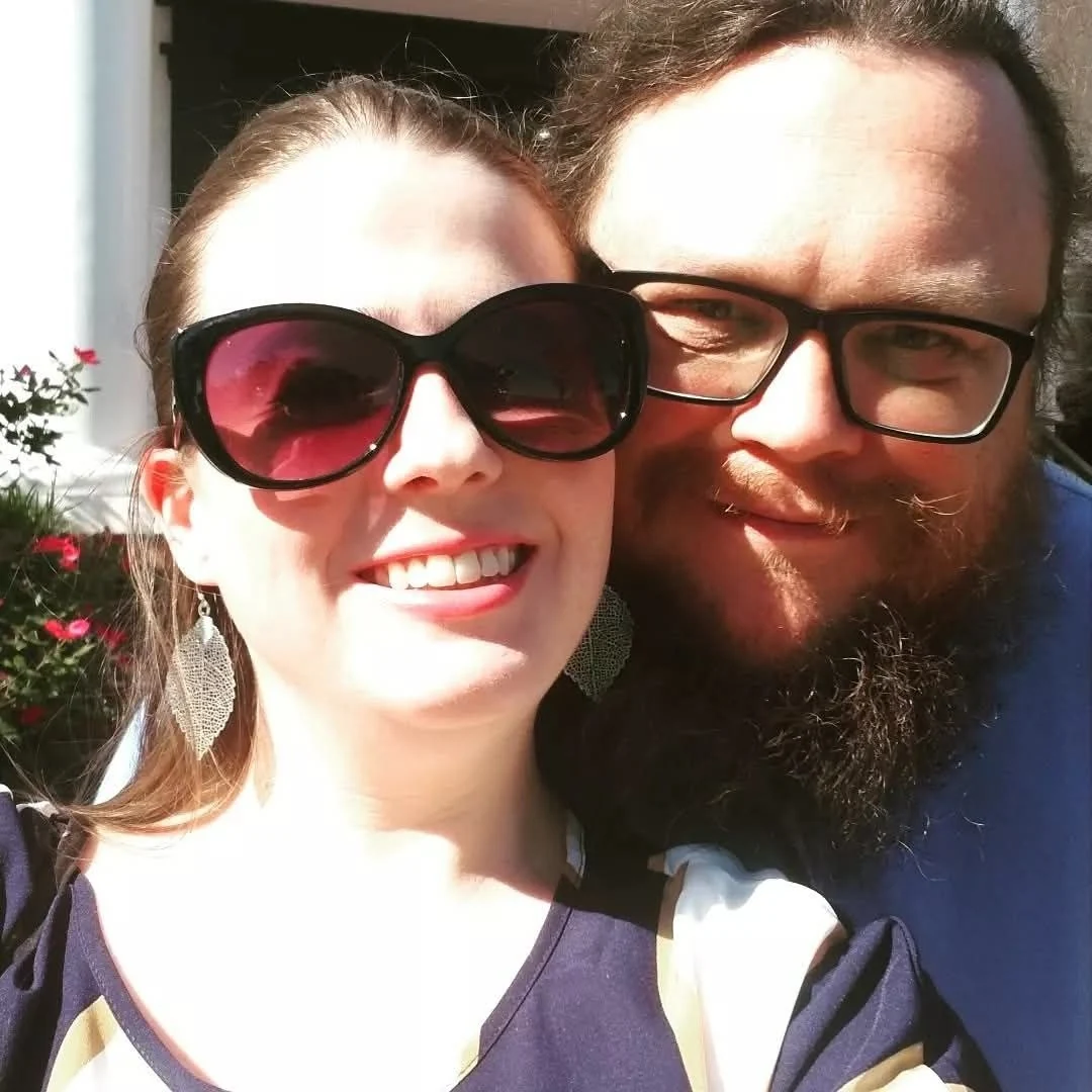 A smiling couple together in the sunshine